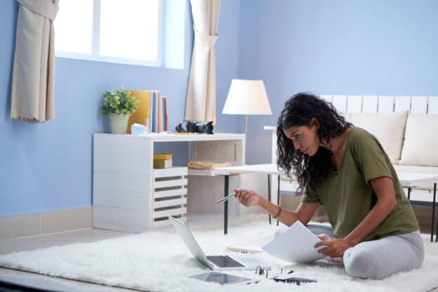 girl working in living room - Titan Business Suites